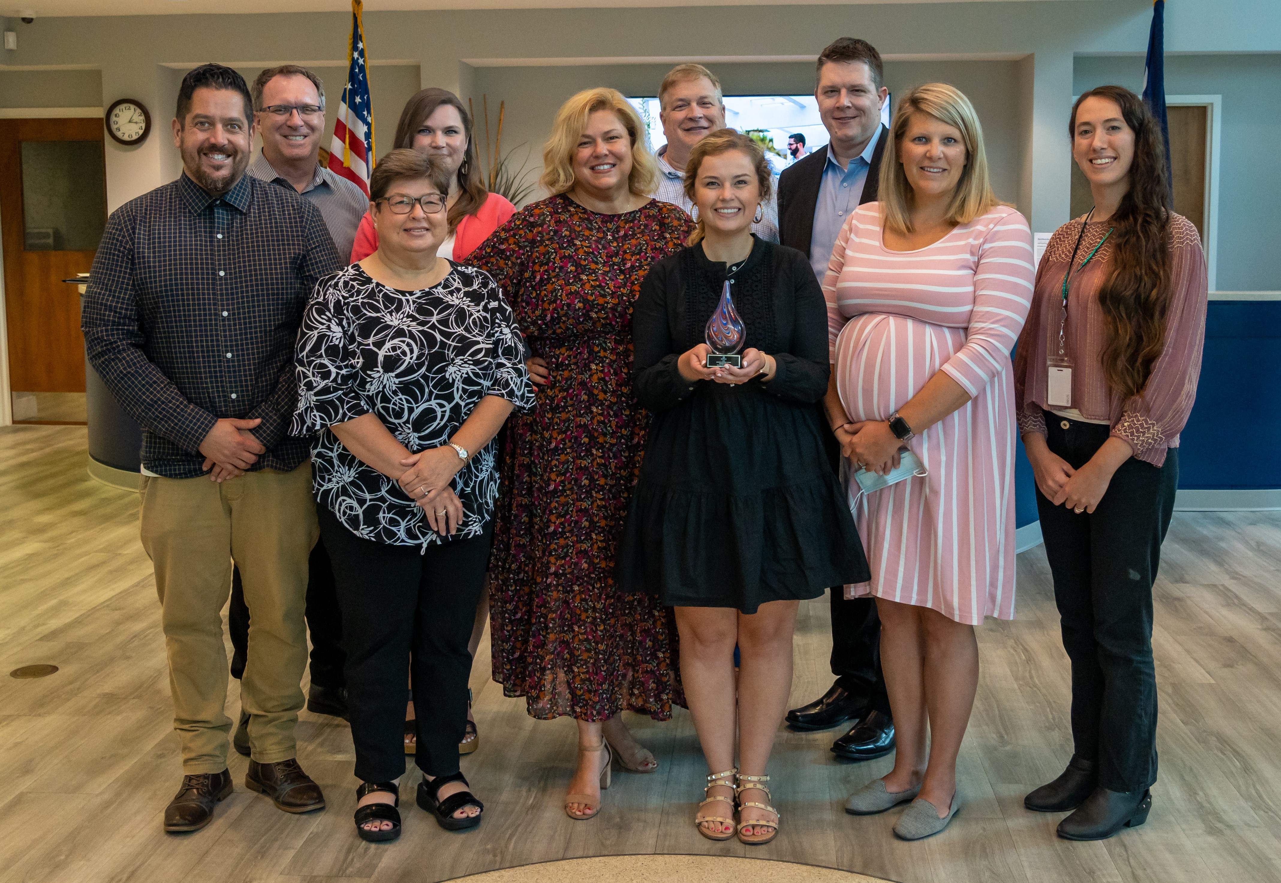 cvb team stands with award in mbacc lobby