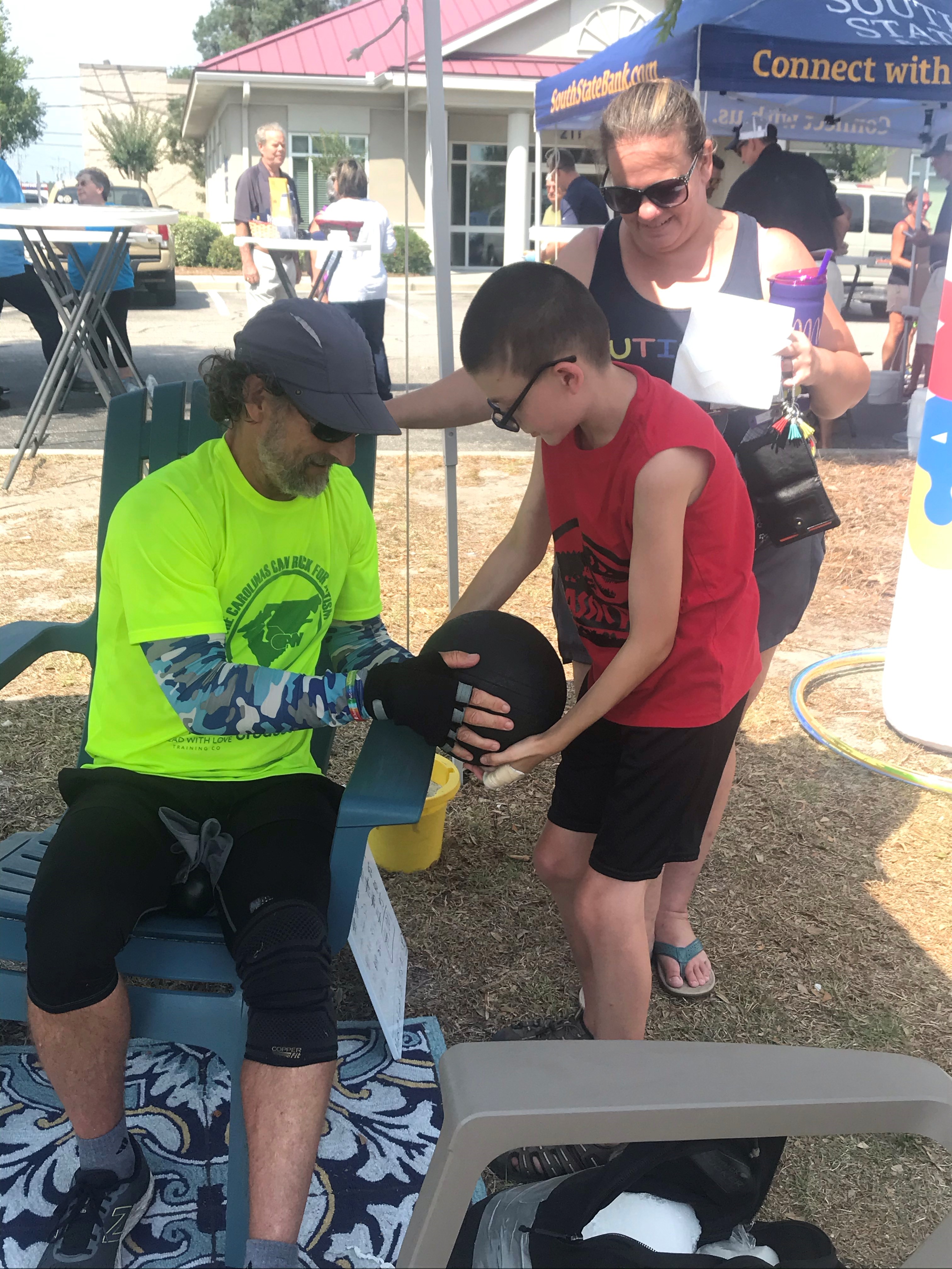 richard sexton shows a kid his 25 pound slamball