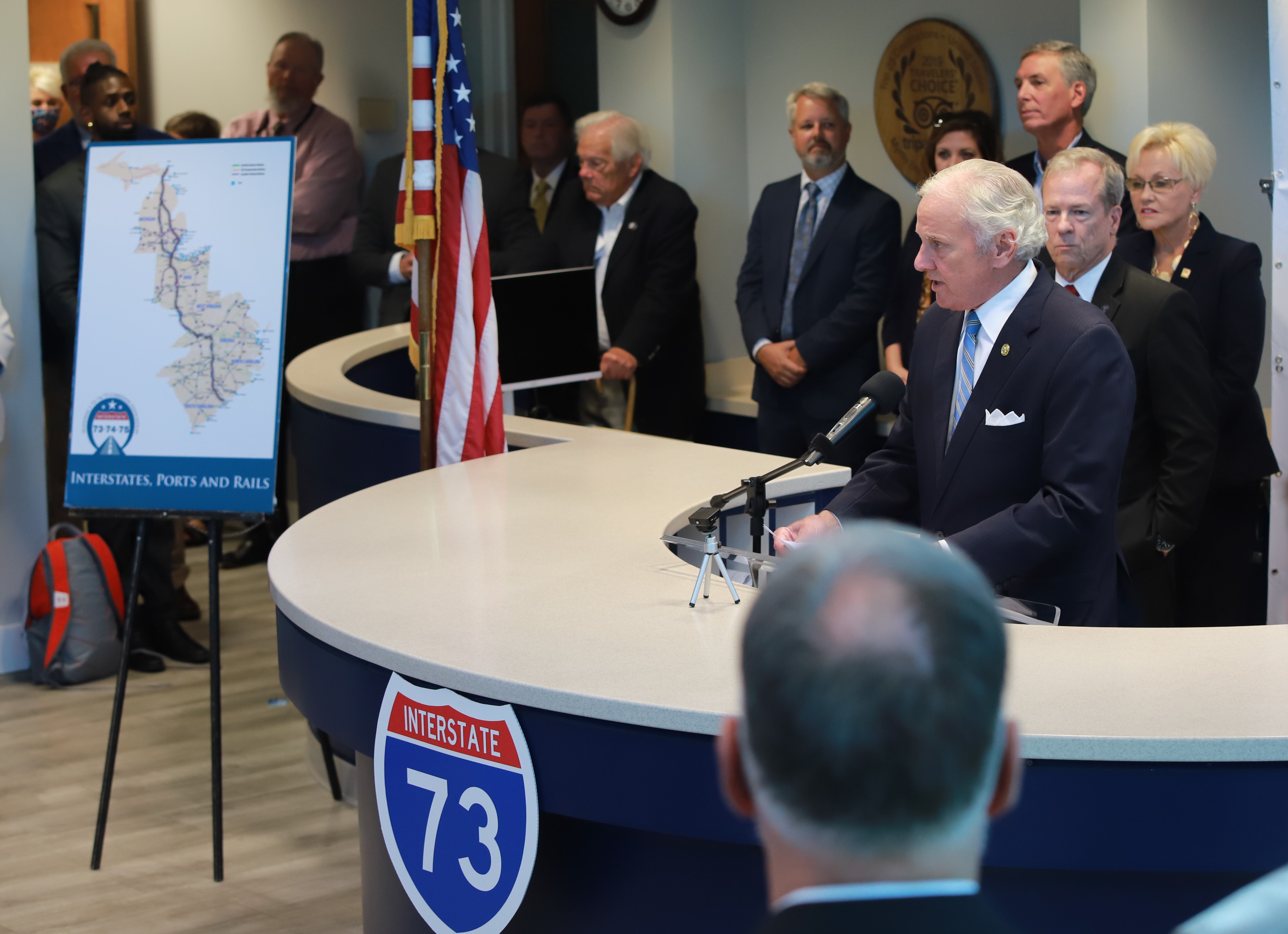 S.C. Gov Henry McMaster stands at podium surrounded by people