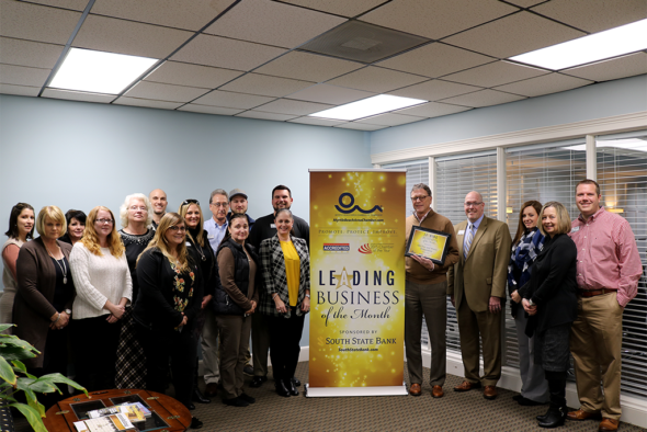 Group photo with leading business banner at A&I