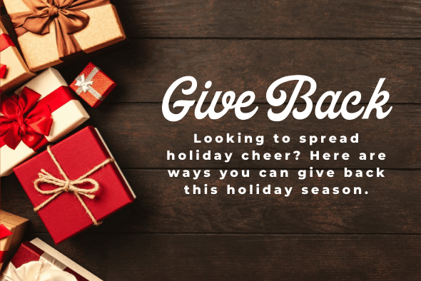 wrapped present boxes on wood table with words reading give back