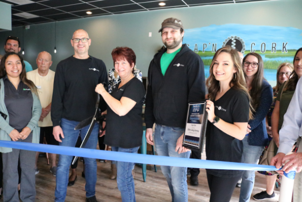 albanese family smiles for photo with scissors for ribbon cutting