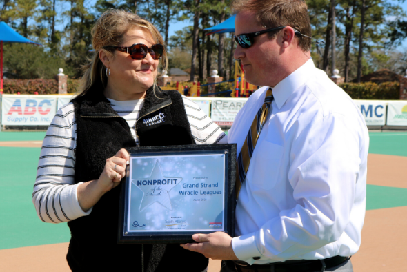 John Rowe presents plaque to Jennifer Averette