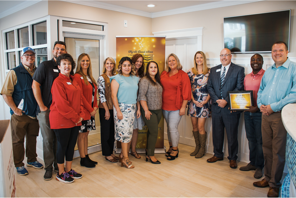 surfside realty staff and chamber volunteers smile for photo