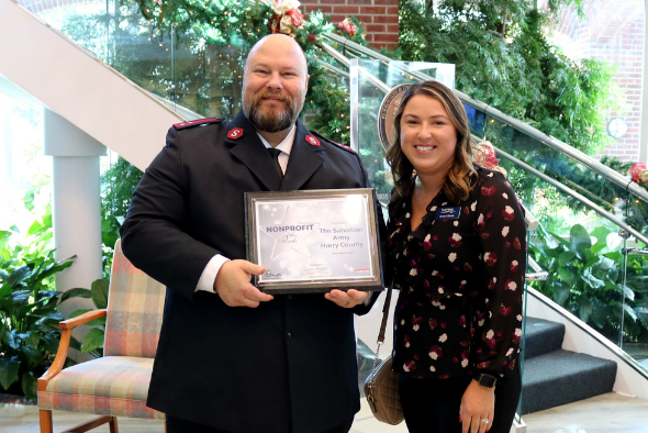 Alison Roark presents award plaque to salvation army