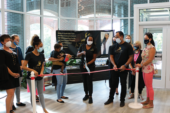 black woman cutting a ceremonial ribbon