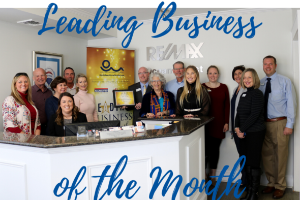 group photo of remax staff, chamber ambassadors and staff with words saying leading business